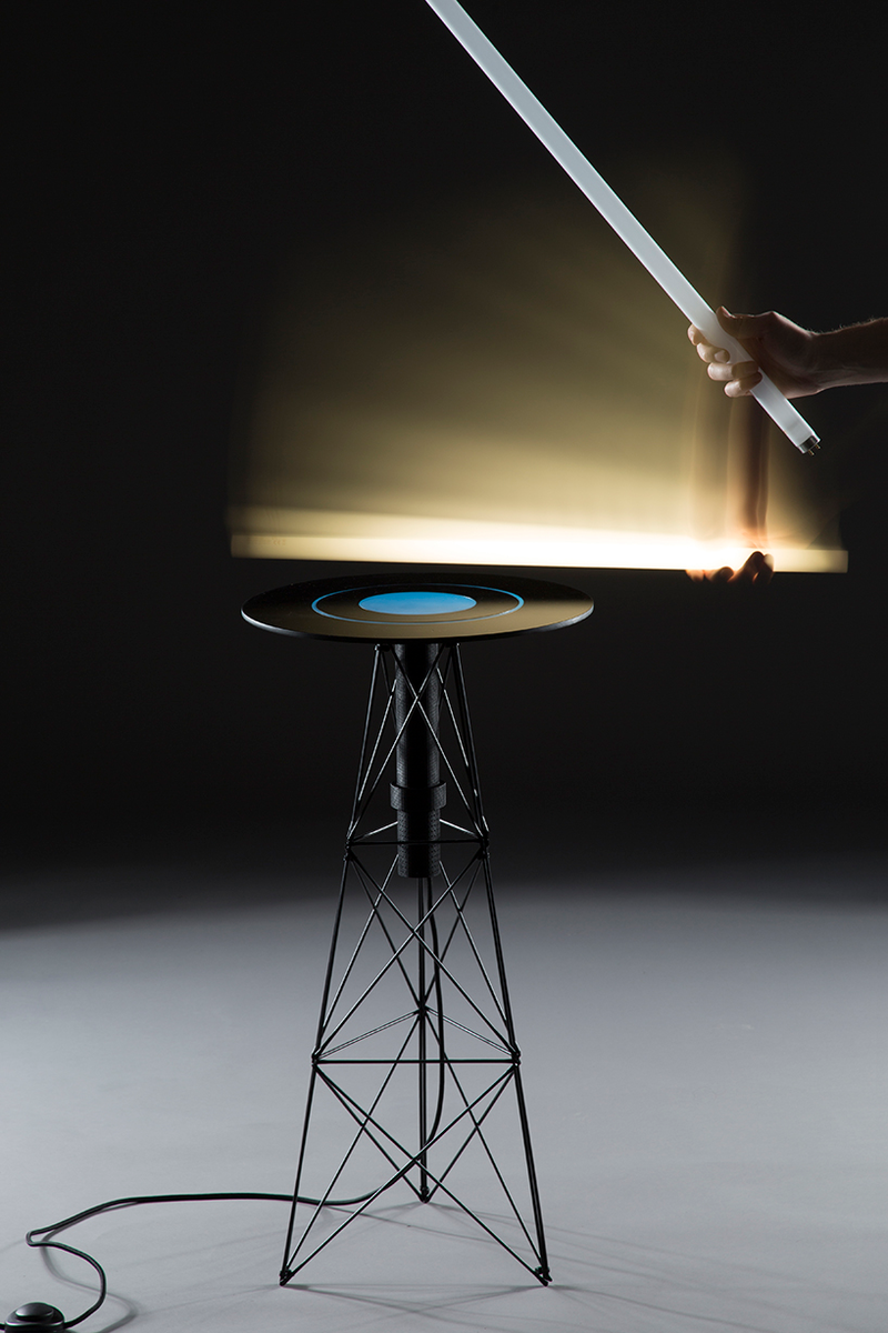 Illustration for article titled This Magical Table's Electromagnetic Field Turns On Nearby Light Bulbs